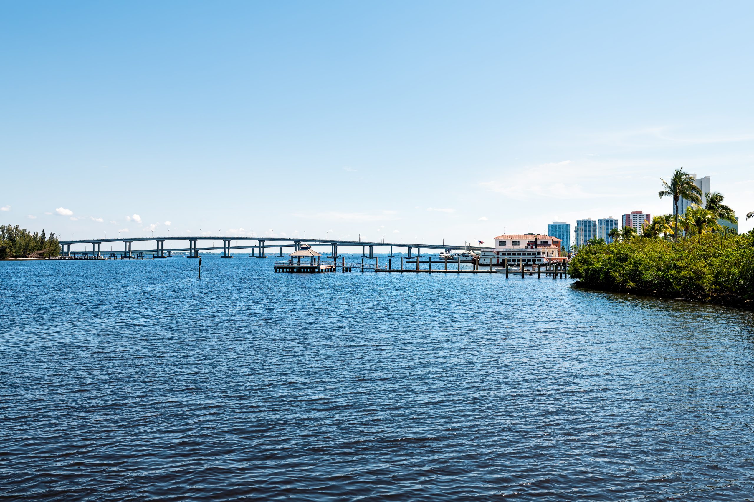 Bridges in marina harbor dock on Caloosahatchee River in Fort Myers, Florida gulf of mexico coast with pier wharf gazebo pavilion pool with chairs outside